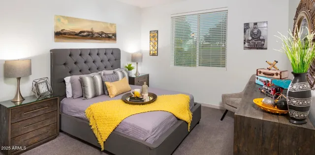 a bedroom with furniture and a window