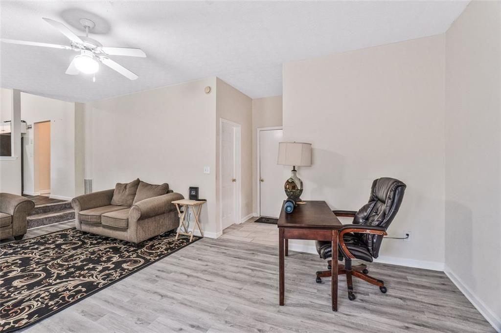 675 Michael Circle Monroe, GA 30655 - Photo 18 of 34 a living room with furniture and a wooden floor
