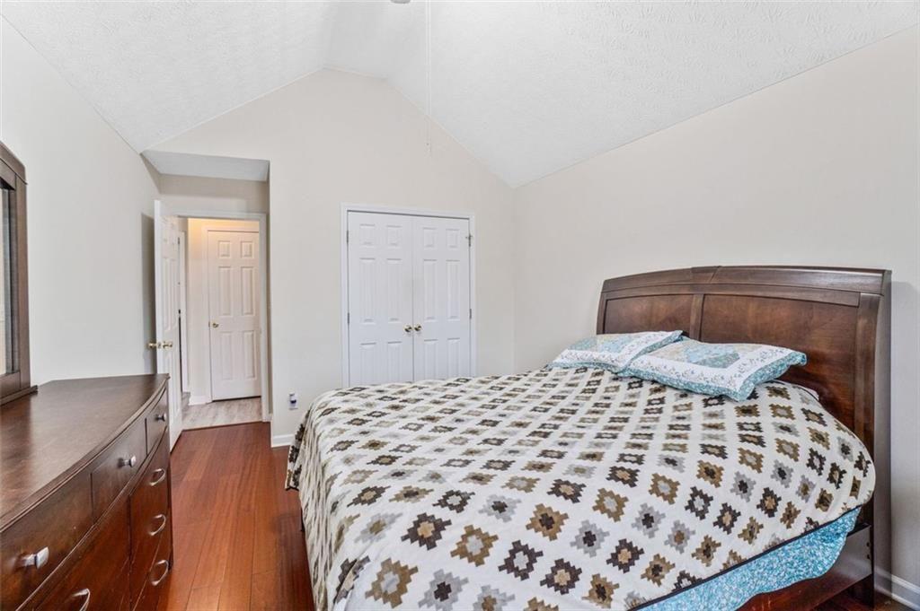 675 Michael Circle Monroe, GA 30655 - Photo 25 of 34 a bedroom with a large bed and a dresser