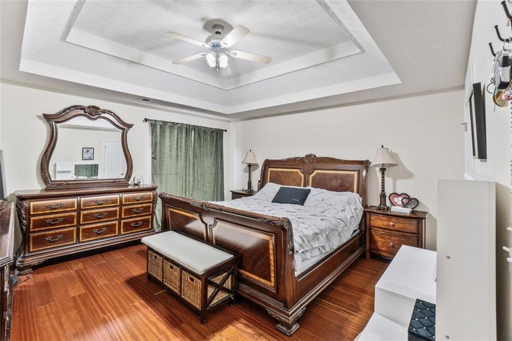 675 Michael Circle Monroe, GA 30655 - Photo 27 of 34 a bedroom with a bed and wooden floor