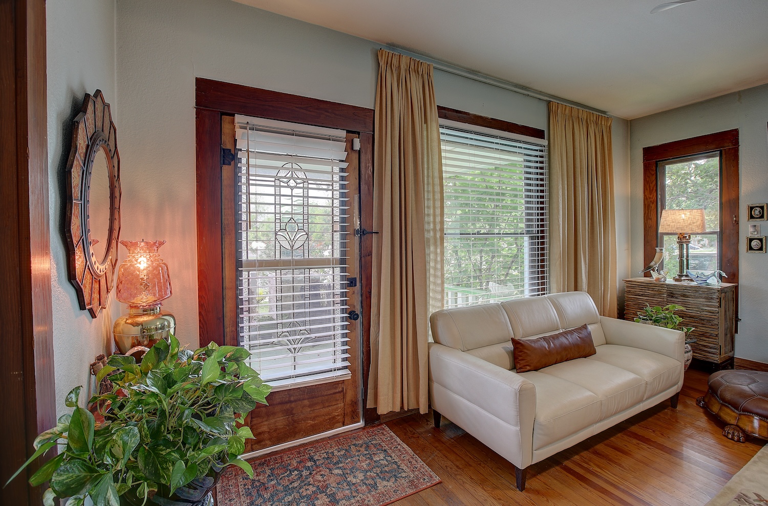 1903 South Austin Avenue Georgetown, TX 78626 - Photo 12 of 40 The clear stained glass front door welcomes you into the gathering room. Blinds convey. Draperies do not. Many large trees and mature landscaping allow dappled natural light to stream in.