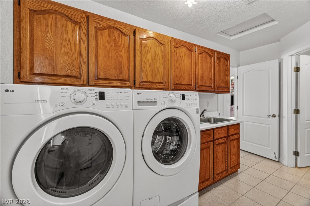 2055 Cholla Way Laughlin, NV 89029 - Photo 41 of 87 Ample cabinetry and a utility sink simplify laundry tasks in this functional space.
