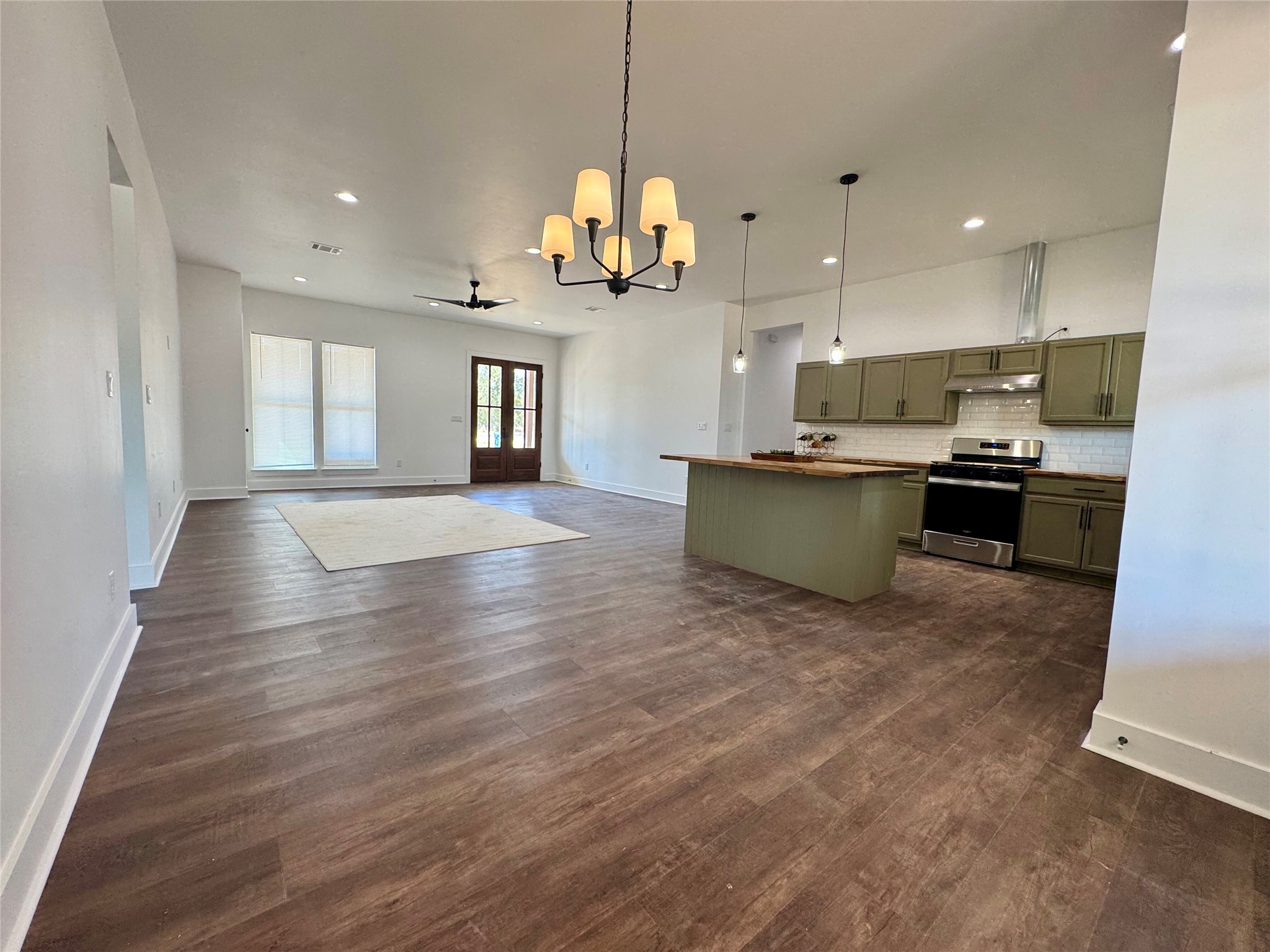1353 Red Town Road, Unit B Elgin, TX 78621 - Photo 11 of 26 a view of a kitchen with kitchen island wooden floor center island and stainless steel appliances