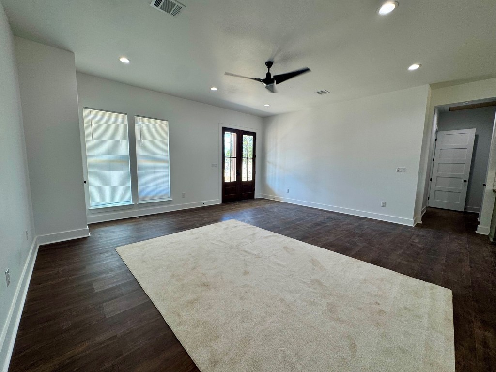 1353 Red Town Road, Unit B Elgin, TX 78621 - Photo 12 of 26 an empty room with wooden floor and windows