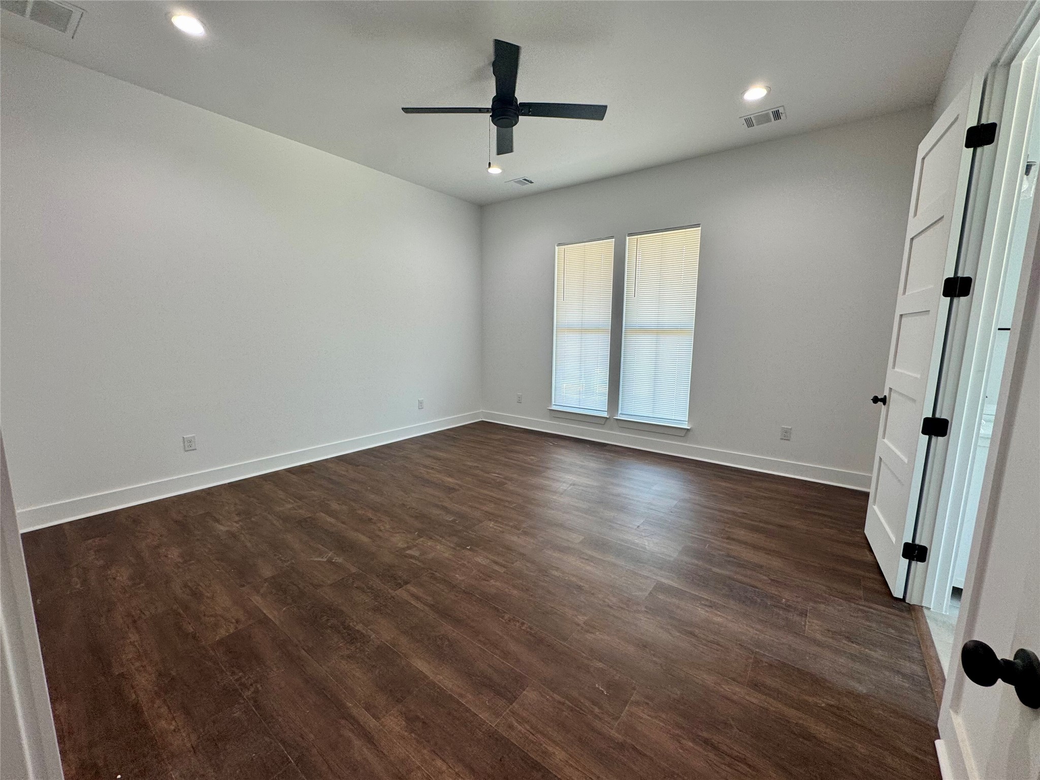 1353 Red Town Road, Unit B Elgin, TX 78621 - Photo 16 of 26 an empty room with wooden floor and a ceiling fan