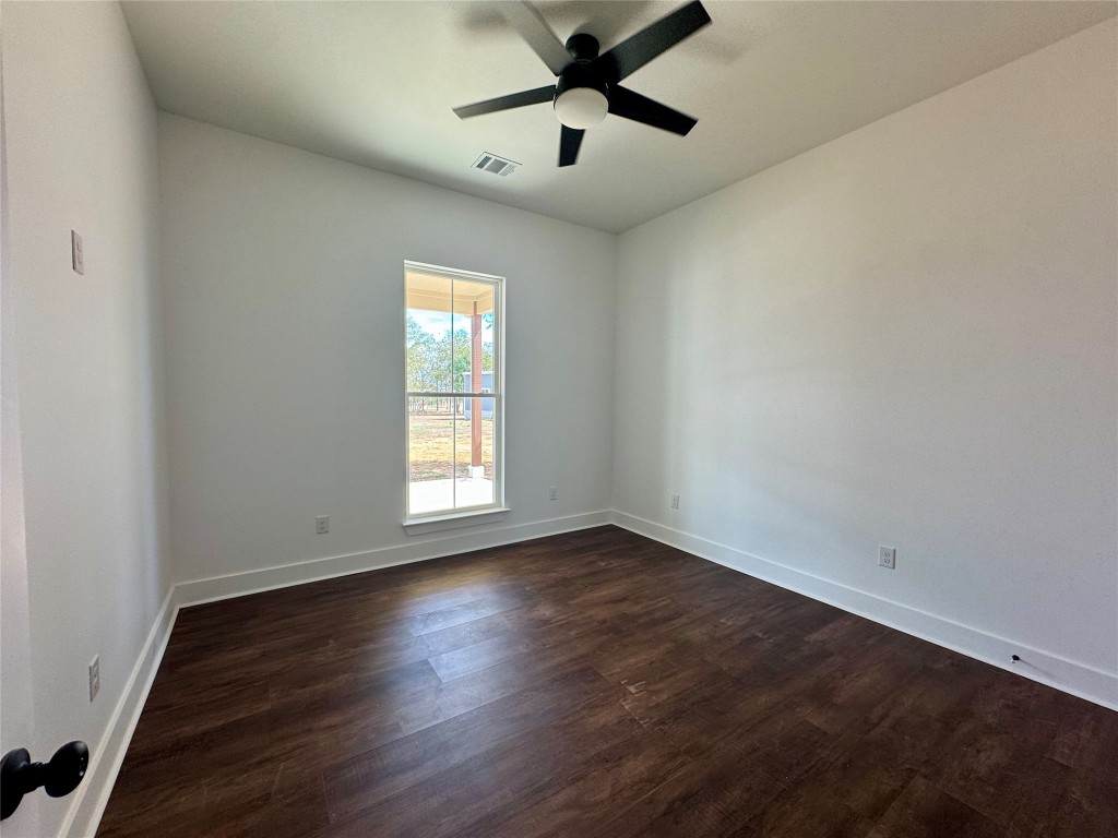 1353 Red Town Road, Unit B Elgin, TX 78621 - Photo 21 of 26 a view of an empty room with wooden floor and a window
