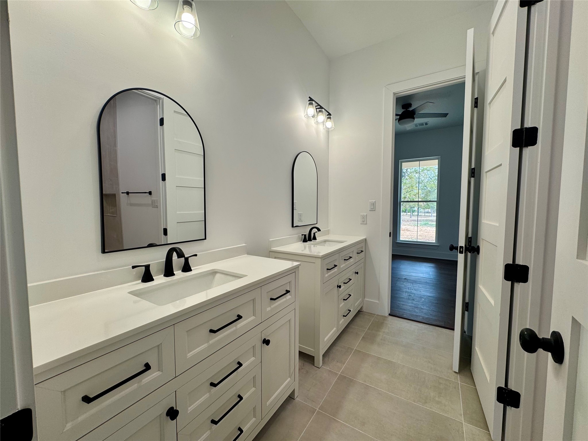 1353 Red Town Road, Unit B Elgin, TX 78621 - Photo 25 of 26 a bathroom with a double vanity sink and mirror with shower
