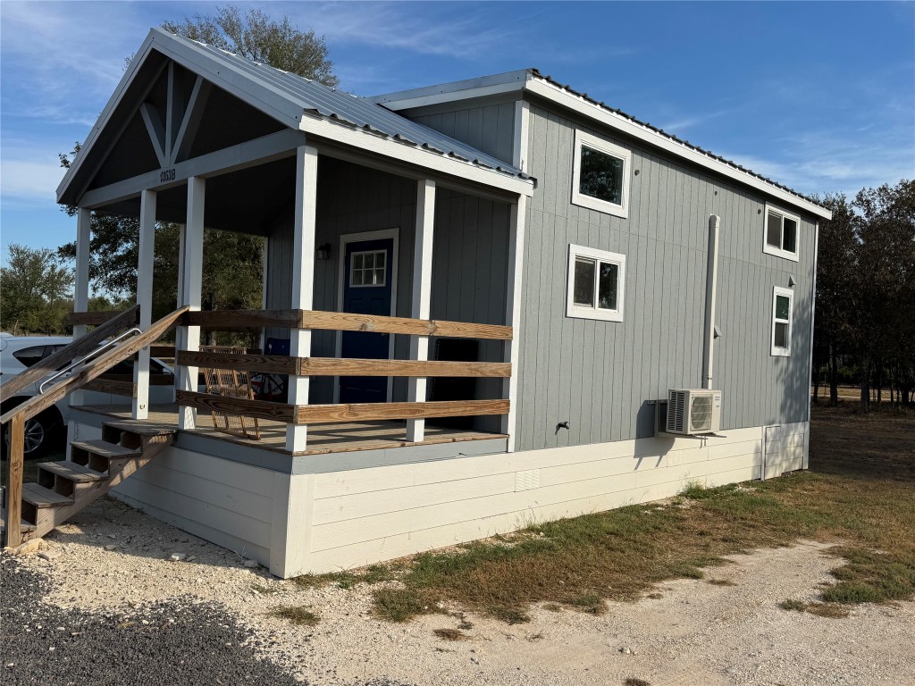 1353 Red Town Road, Unit B Elgin, TX 78621 - Photo 7 of 26 a view of a house with wooden walls and a wooden fence