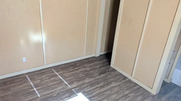 a view of a hallway with wooden floor