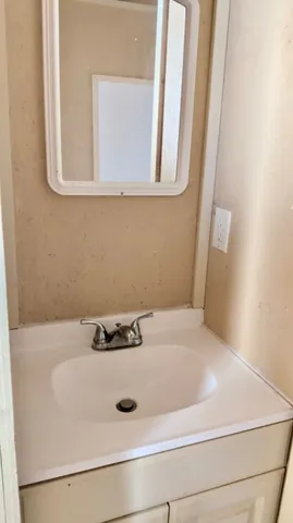 a bathroom with a sink and vanity