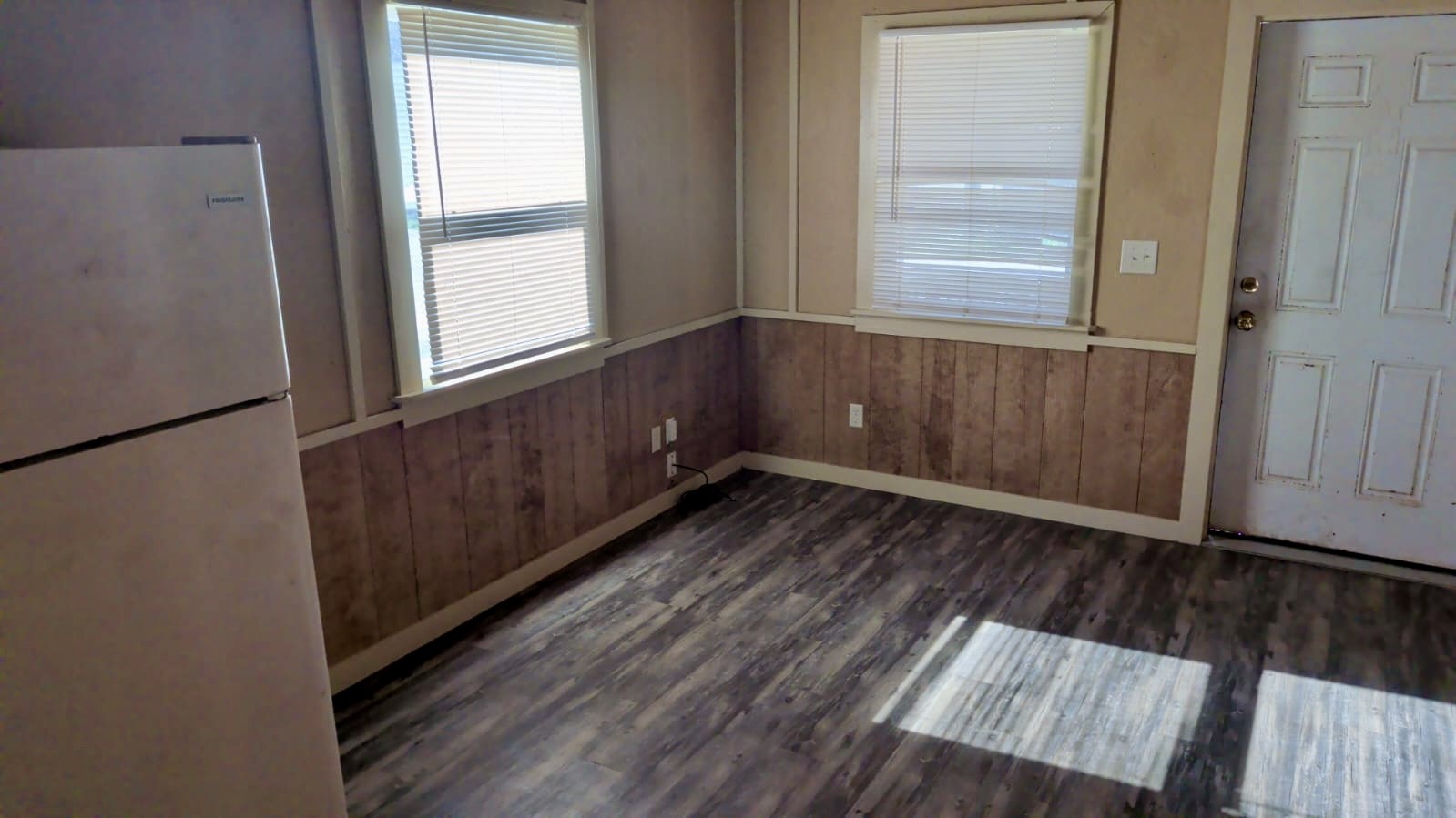 401 North Clegg Street Trinity, TX 75862 - Photo 3 of 15 an empty room with wooden floor and windows