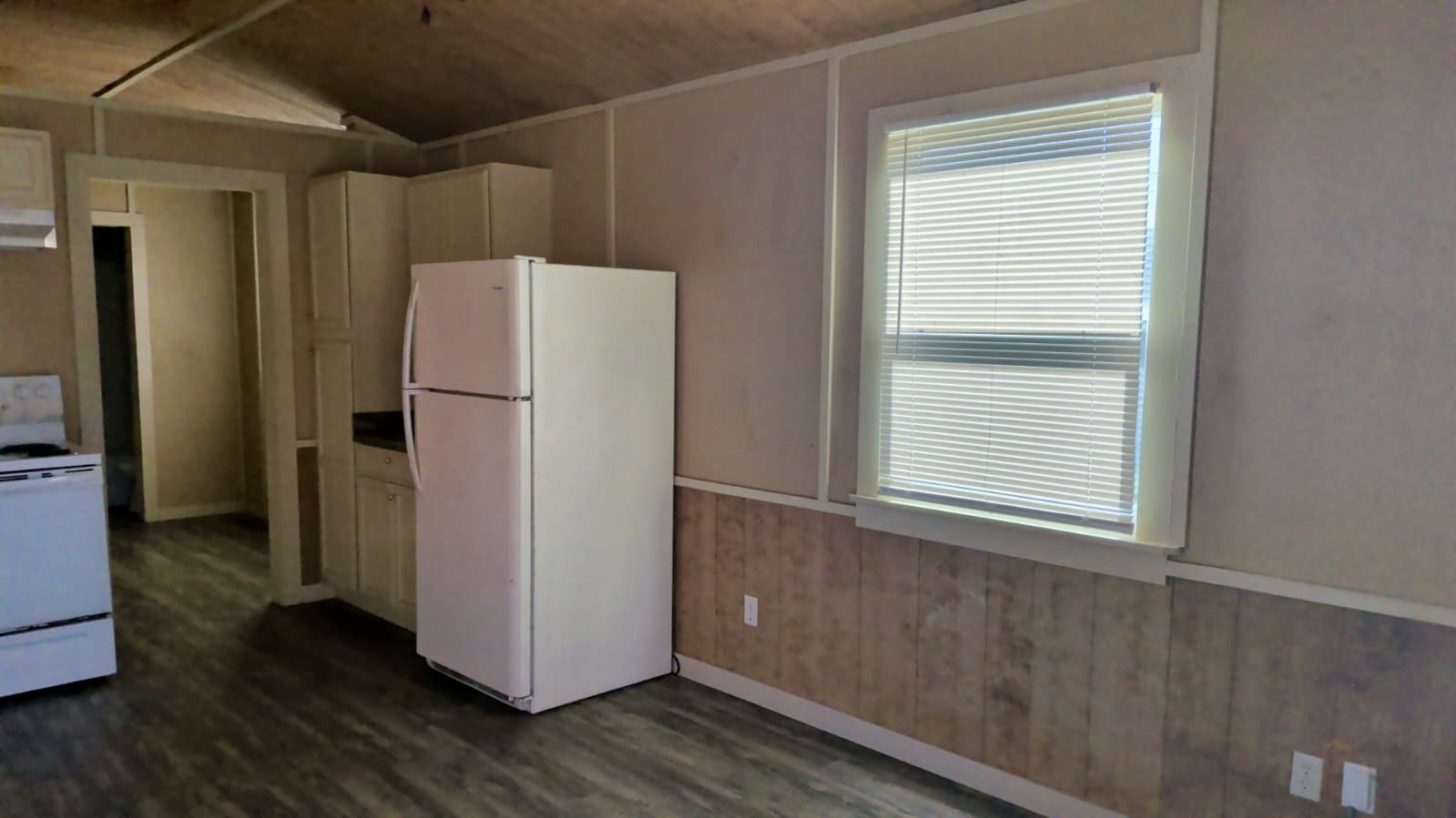401 North Clegg Street Trinity, TX 75862 - Photo 4 of 15 a view of a kitchen with wooden floor and a refrigerator