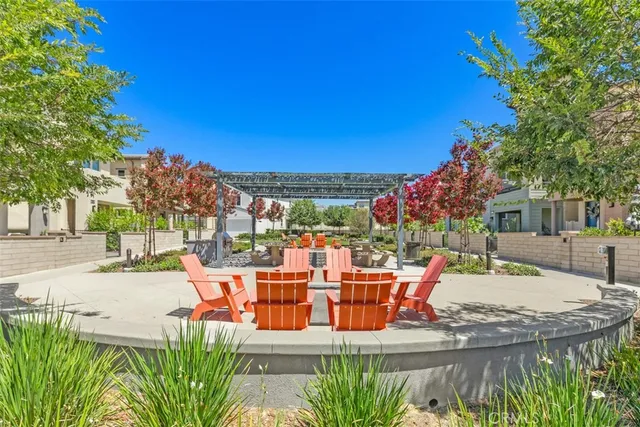 a view of a patio with couches table and chairs and potted plants