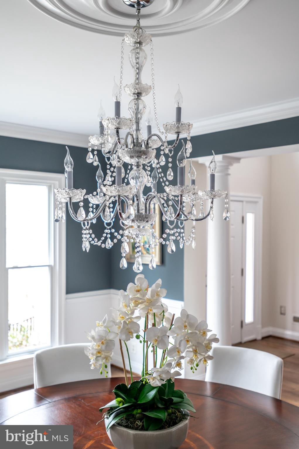5400 Mohican Road Bethesda, MD 20816 - Photo 12 of 47 a vase of flowers sitting on a table with chandelier