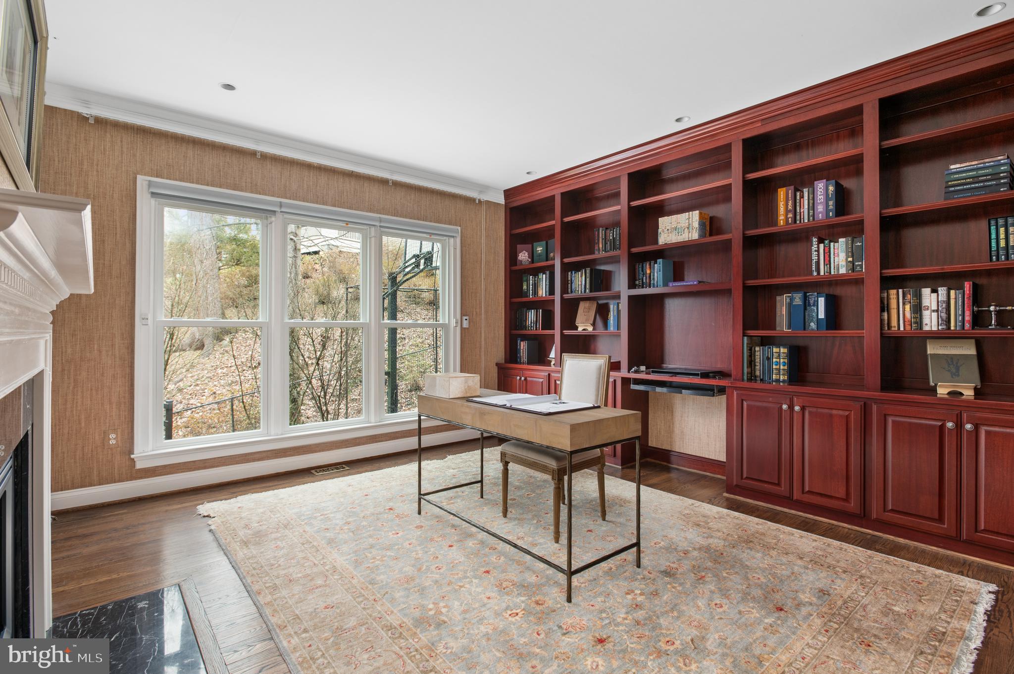 5400 Mohican Road Bethesda, MD 20816 - Photo 16 of 47 a view of a workspace with furniture and a bookshelf