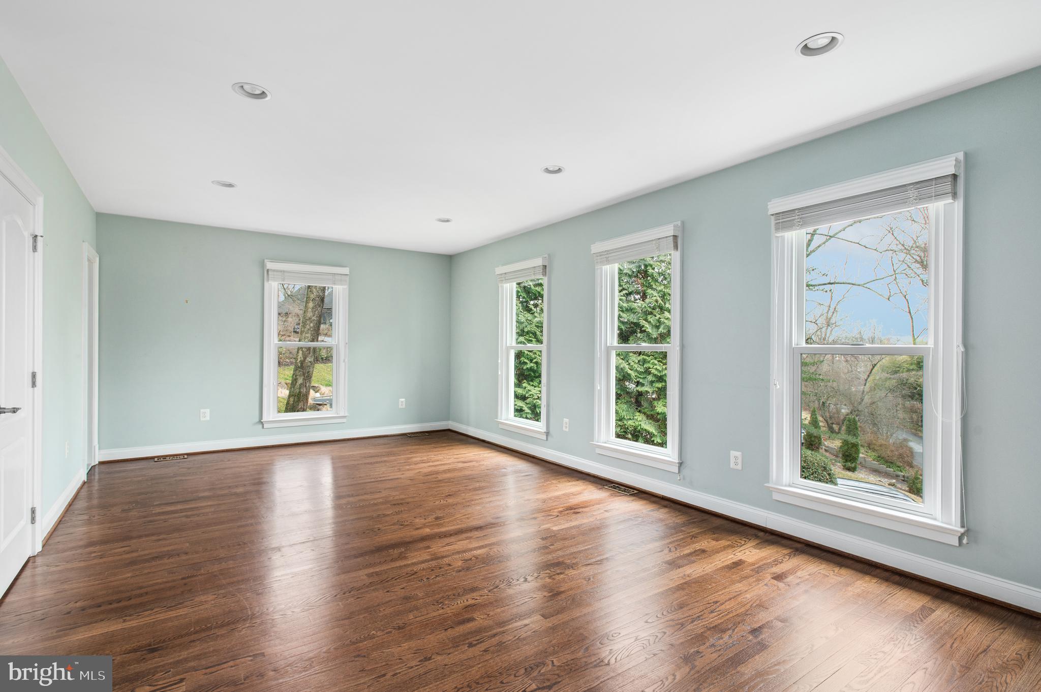5400 Mohican Road Bethesda, MD 20816 - Photo 19 of 47 a view of an empty room with wooden floor and a window