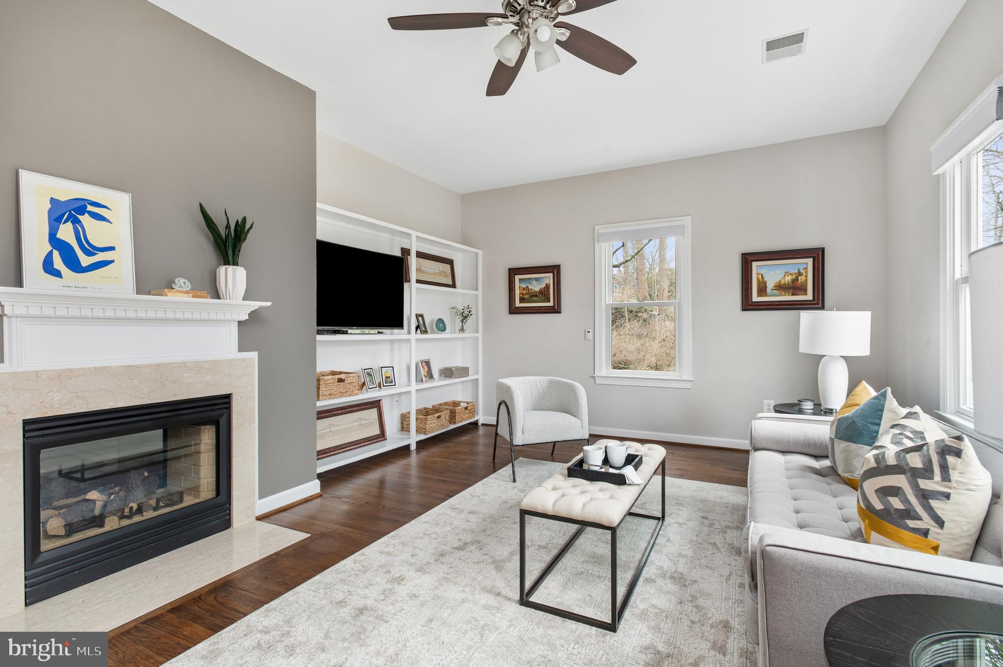 5400 Mohican Road Bethesda, MD 20816 - Photo 25 of 47 a living room with furniture a fireplace and a flat screen tv