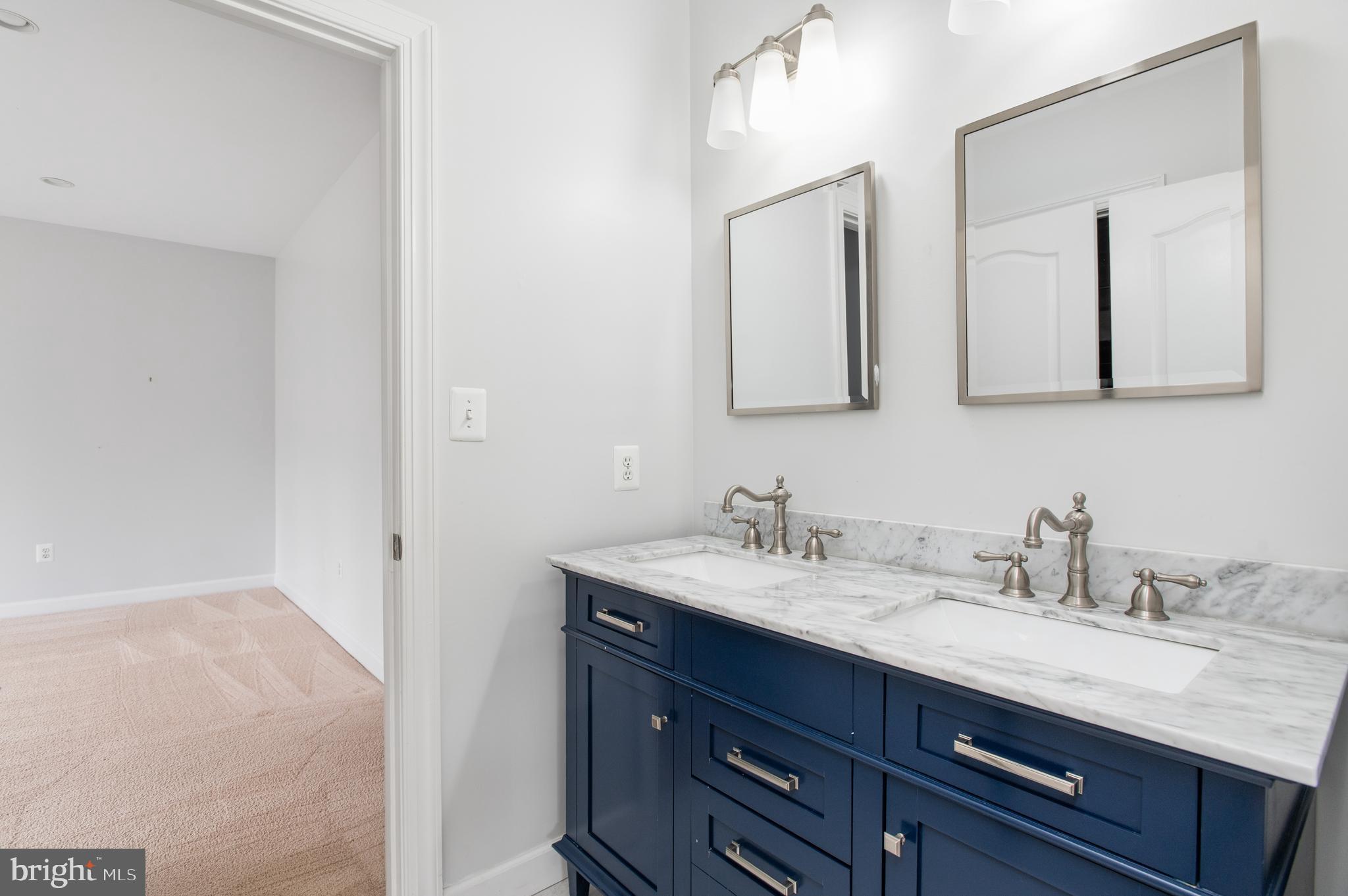 5400 Mohican Road Bethesda, MD 20816 - Photo 30 of 47 a bathroom with a granite countertop sink vanity and mirror