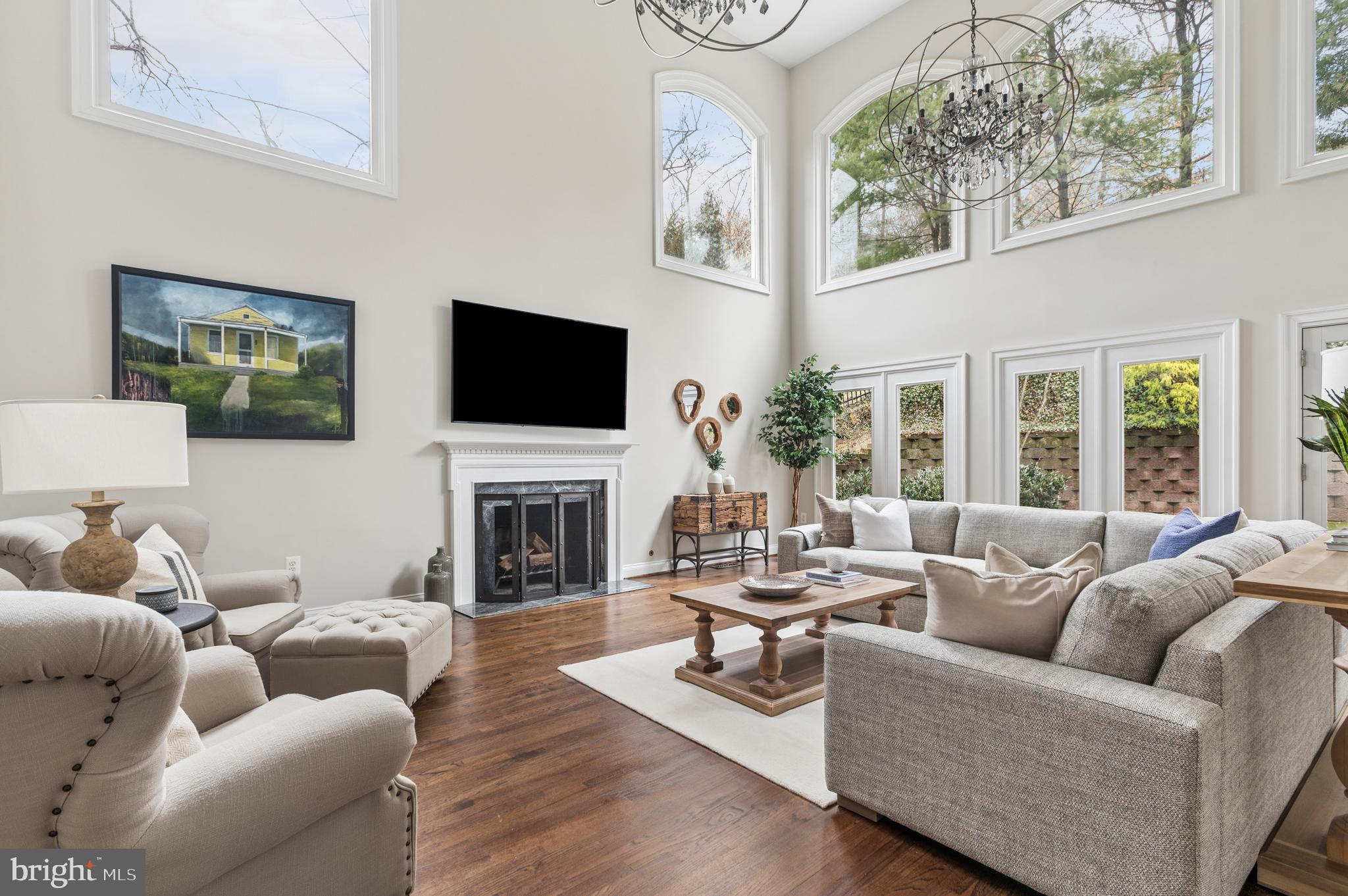 5400 Mohican Road Bethesda, MD 20816 - Photo 3 of 47 a living room with furniture a fireplace and a flat screen tv