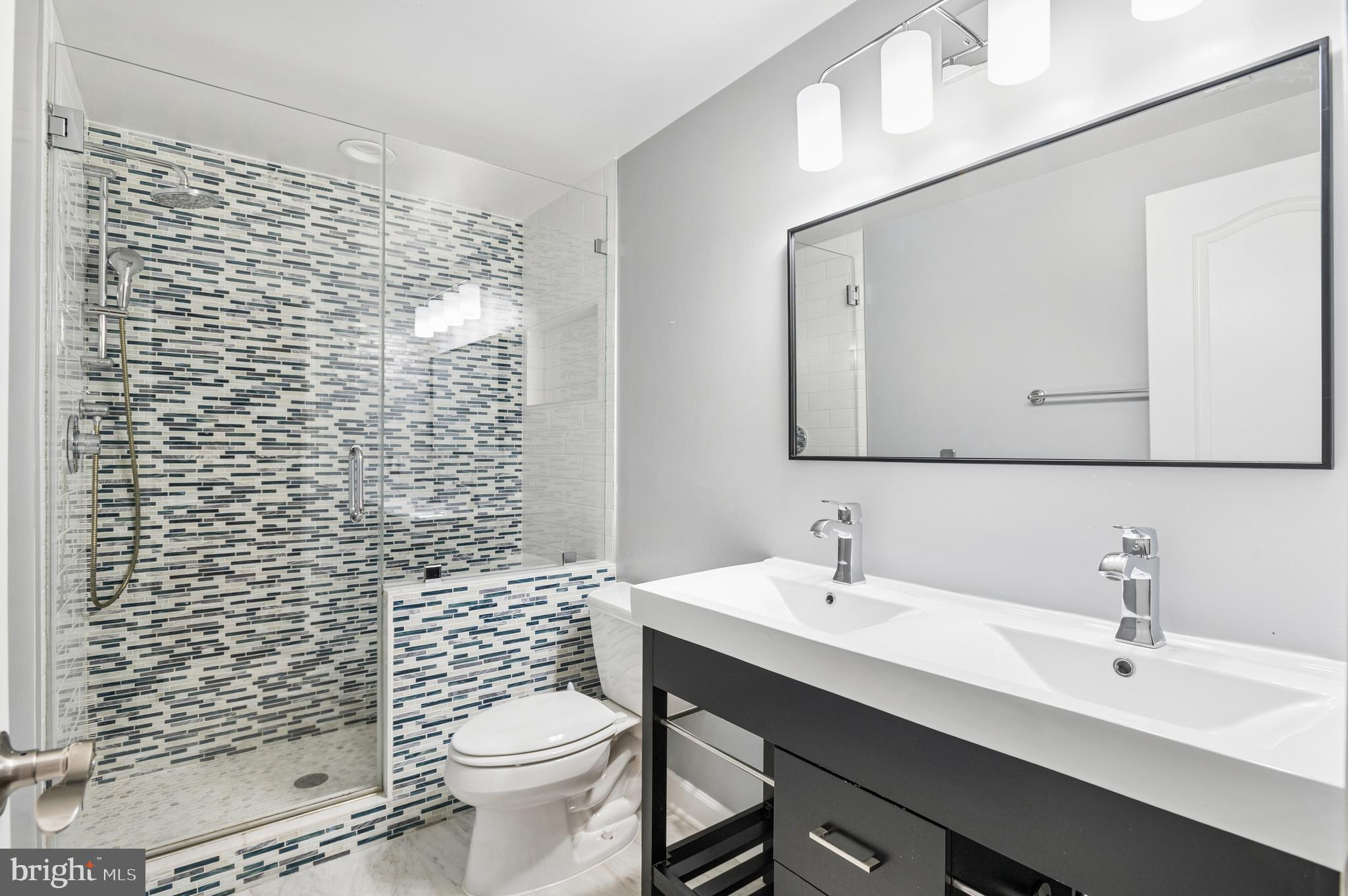 5400 Mohican Road Bethesda, MD 20816 - Photo 38 of 47 a bathroom with a sink a toilet and shower