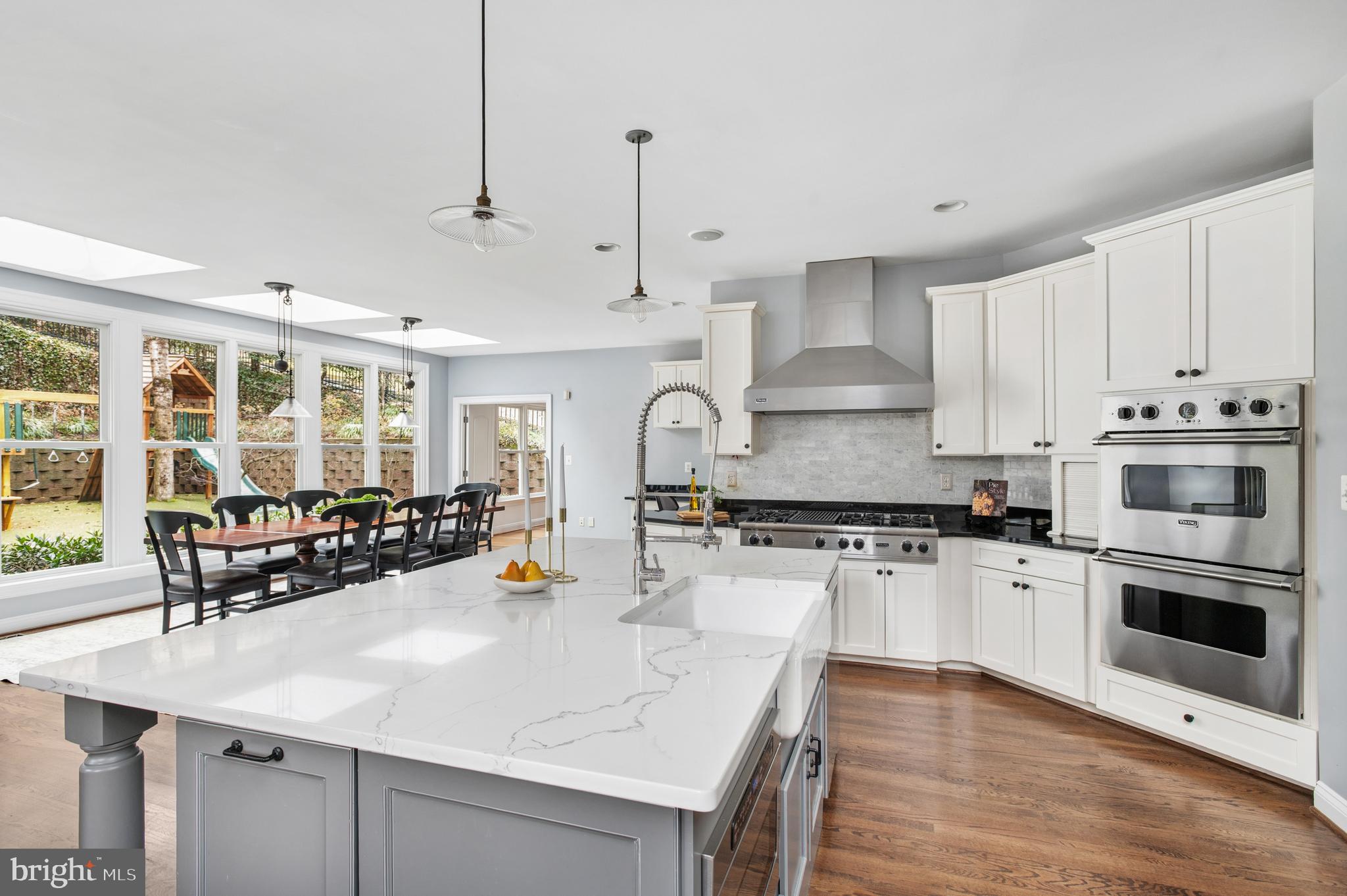 5400 Mohican Road Bethesda, MD 20816 - Photo 5 of 47 a kitchen with stainless steel appliances and wooden cabinets