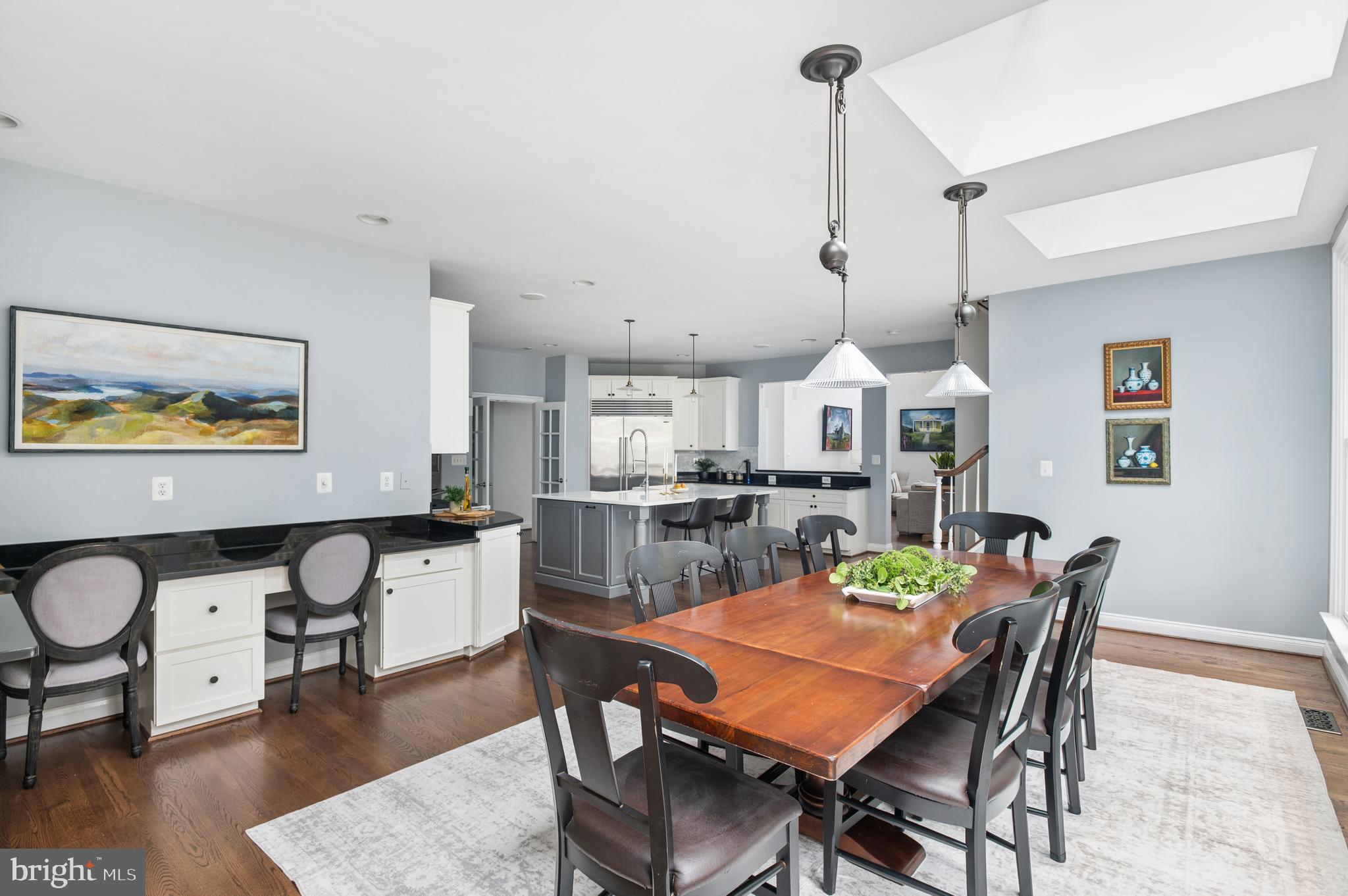 5400 Mohican Road Bethesda, MD 20816 - Photo 9 of 47 a dining room with wooden floor a chandelier a wooden table and chairs