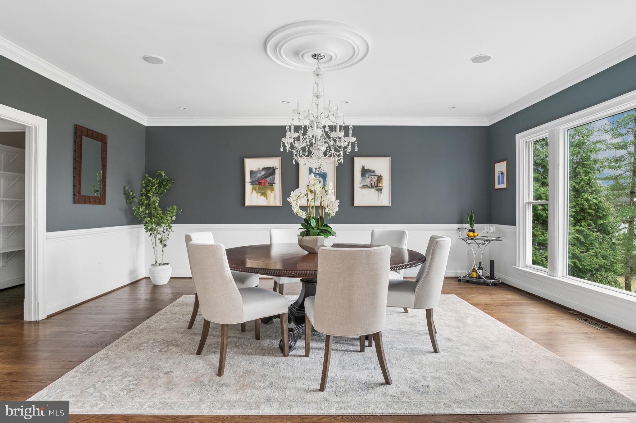 5400 Mohican Road Bethesda, MD 20816 - Photo 10 of 47 a dining room with furniture a large window and wooden floor
