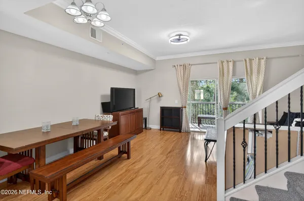 a view of a room with furniture and wooden floor