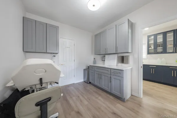 a kitchen with a sink cabinets and wooden floor