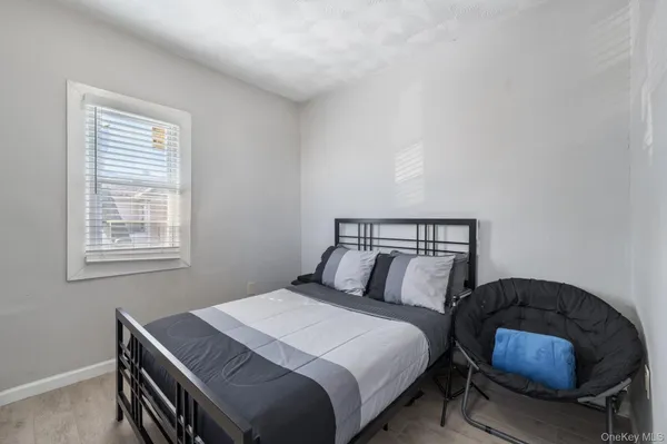 a bedroom with a bed and a mirror