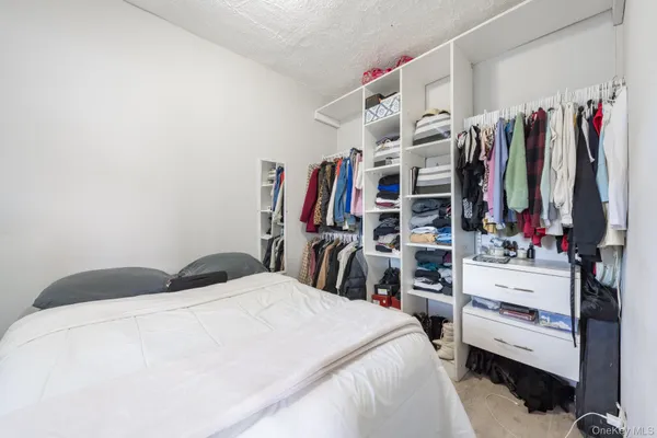 a bedroom with a bed and a walk in closet