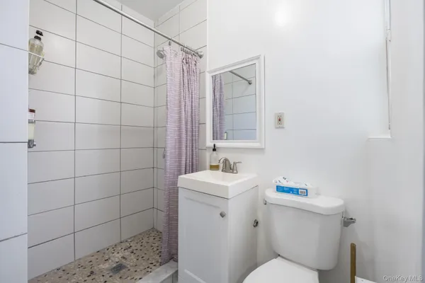 a white toilet sitting next to a bathroom sink