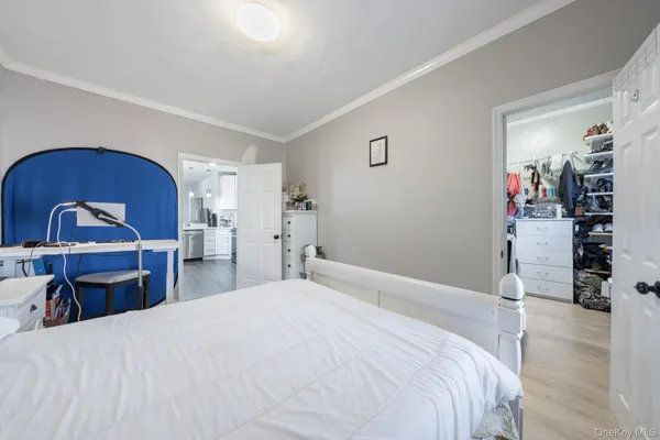 a bedroom with a bed and a mirror on dresser