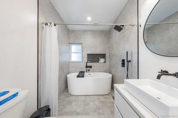 a bathroom with a sink a mirror and a bathtub