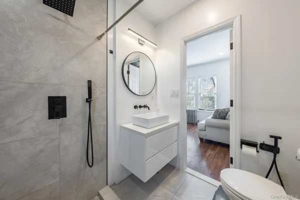 a bathroom with a sink a toilet and a mirror