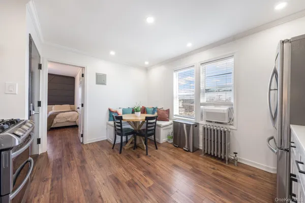 a view of a dining room with furniture window and wooden floor