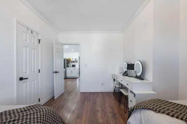 a view of bedroom with a bed and wooden floor