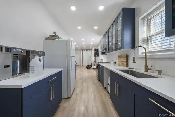 a kitchen with stainless steel appliances kitchen island granite countertop a sink stove and refrigerator