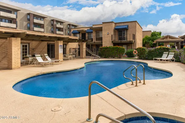 a view of a swimming pool with a patio