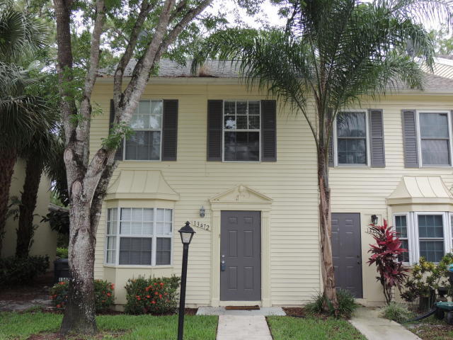 13472 Old Englishtown Road Wellington, FL 33414 - Photo 1 of 18 a front view of a house with garden