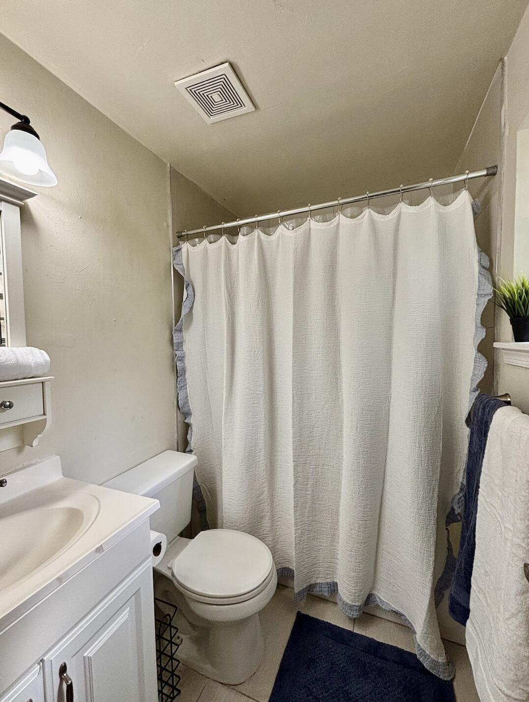 13472 Old Englishtown Road Wellington, FL 33414 - Photo 12 of 18 a white toilet sitting next to a bathroom sink