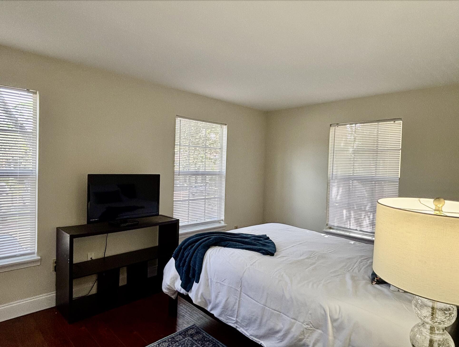 13472 Old Englishtown Road Wellington, FL 33414 - Photo 13 of 18 a bedroom with a bed and a flat screen tv