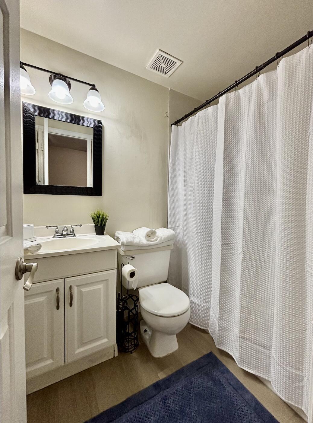13472 Old Englishtown Road Wellington, FL 33414 - Photo 15 of 18 a bathroom with a toilet sink and mirror