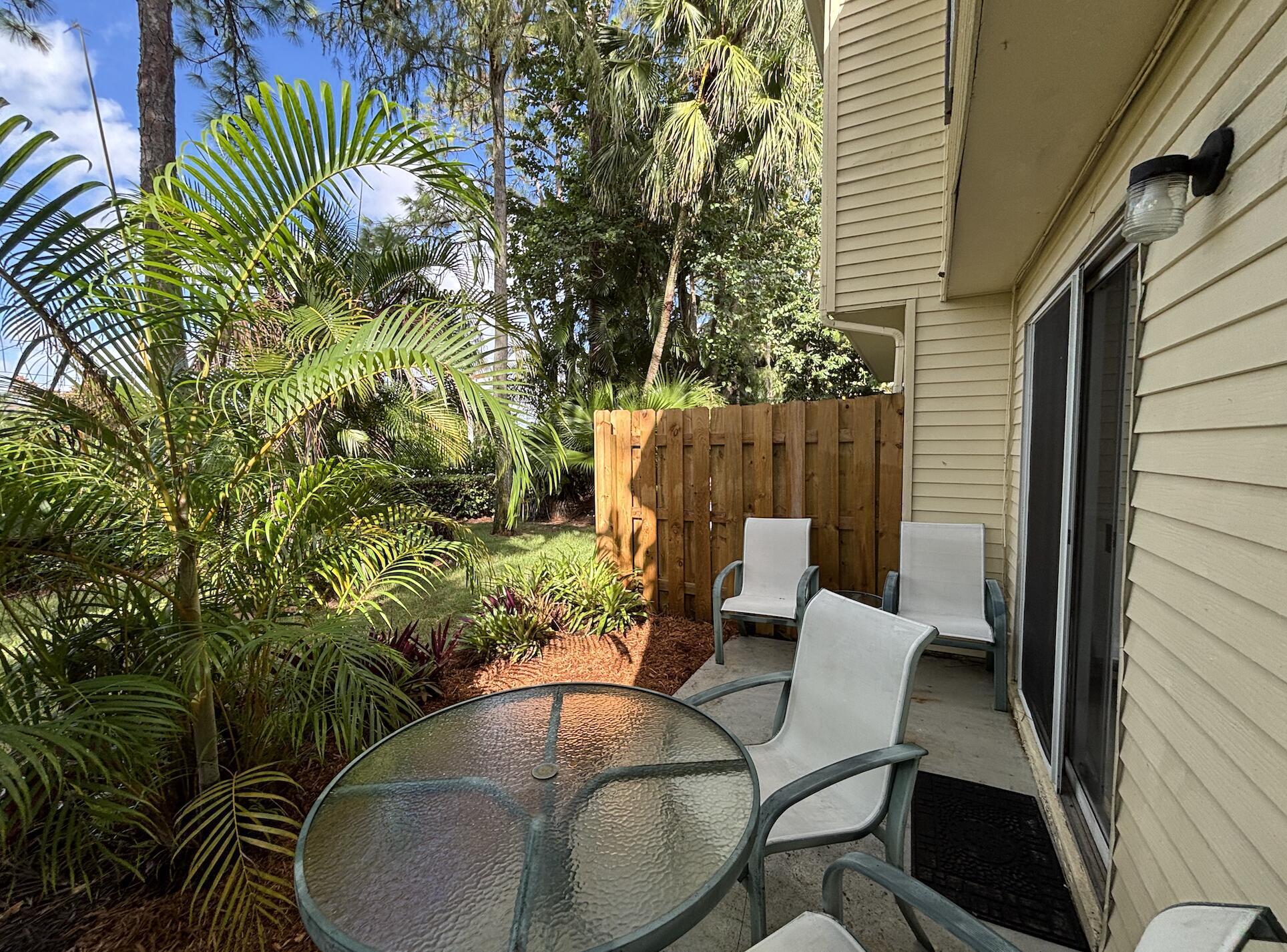 13472 Old Englishtown Road Wellington, FL 33414 - Photo 16 of 18 a backyard of a house with table and chairs