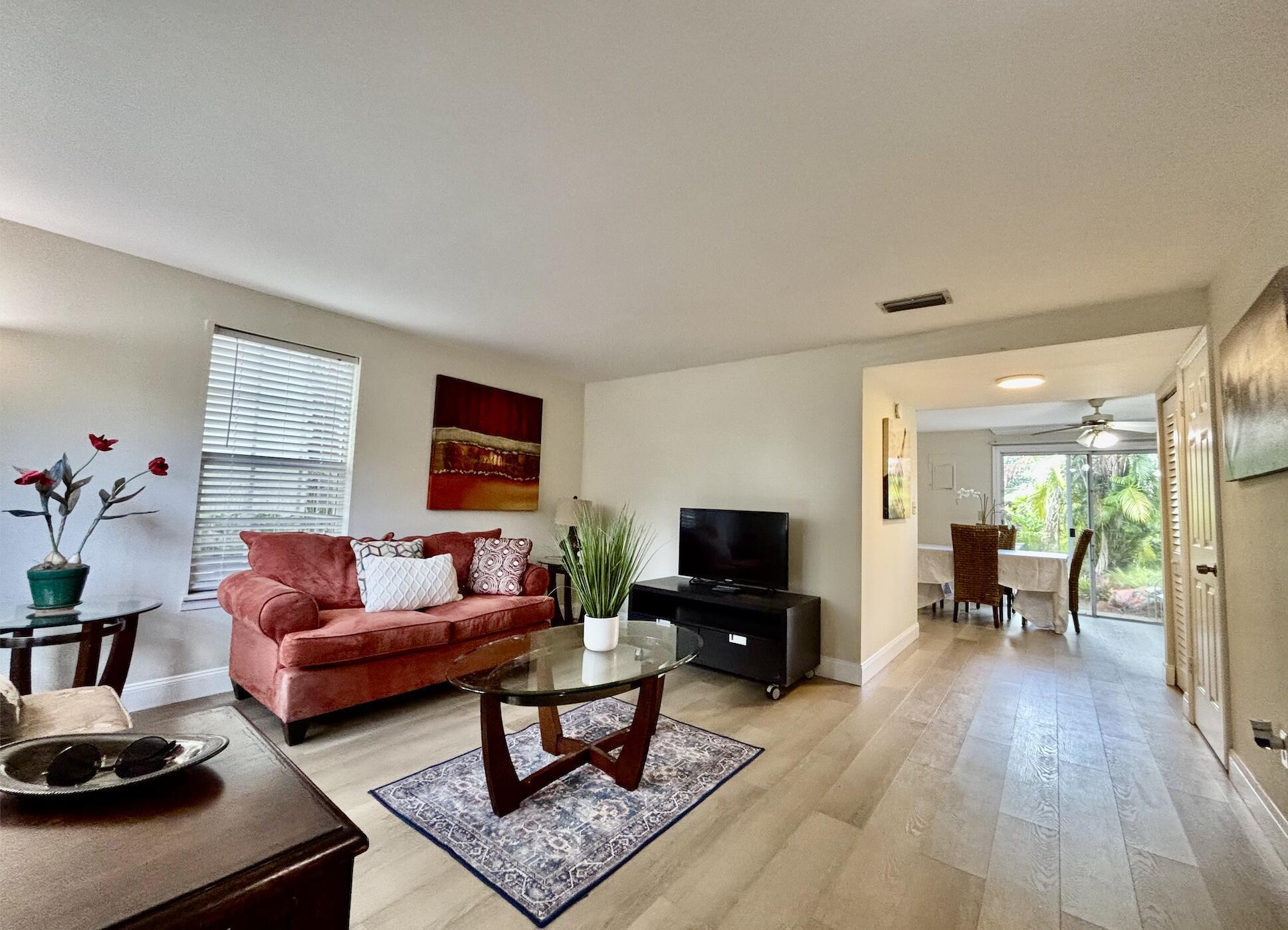 13472 Old Englishtown Road Wellington, FL 33414 - Photo 4 of 18 a living room with furniture and a wooden floor