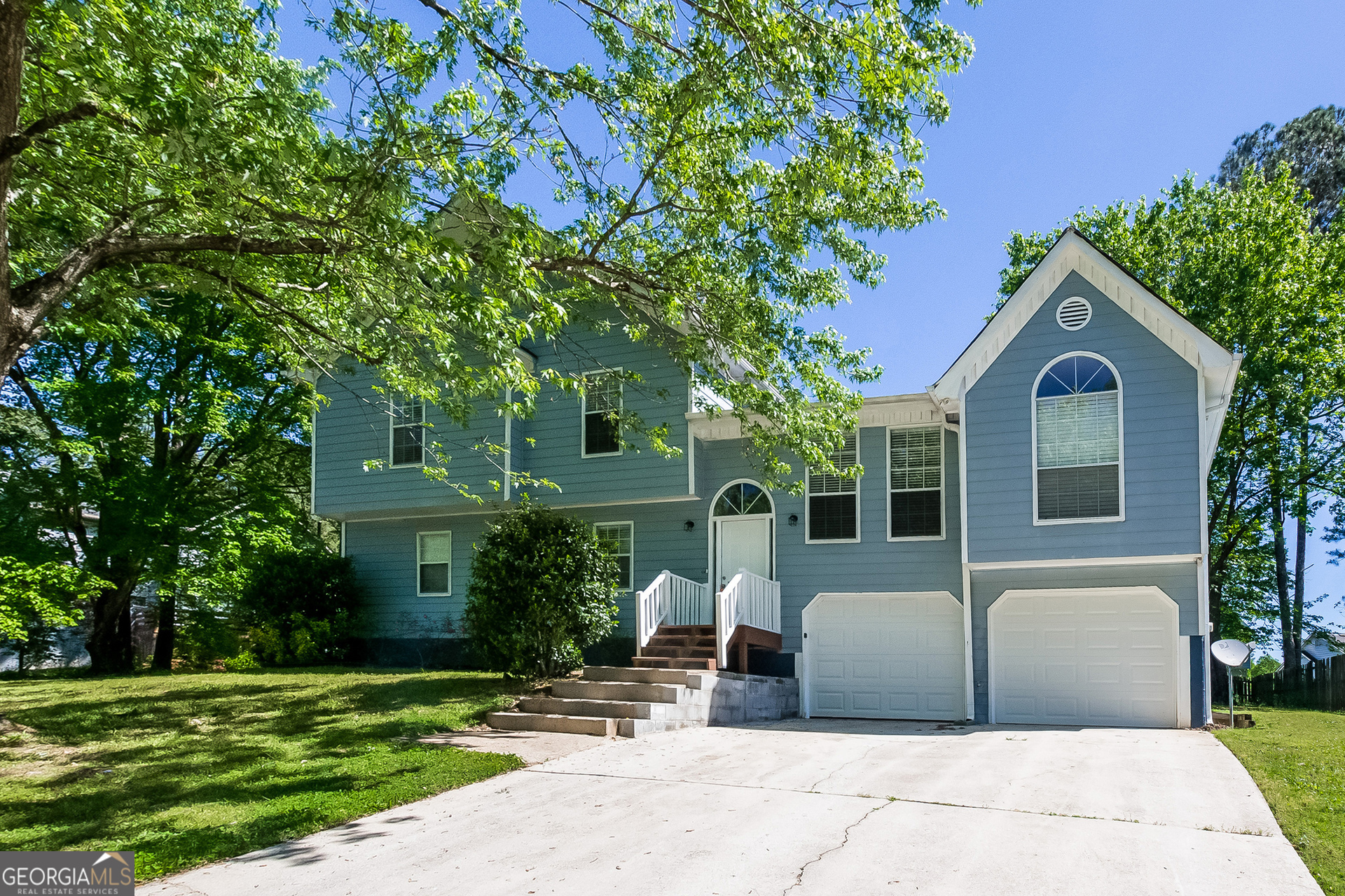 a front view of a house with a garden