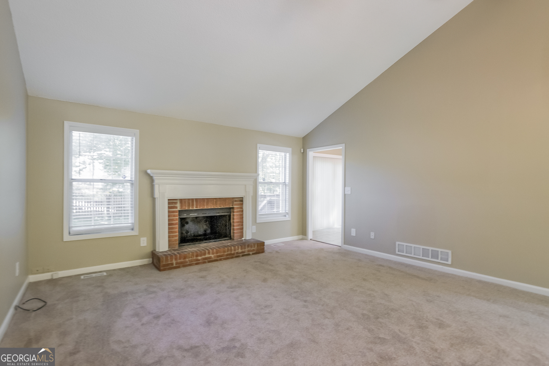 2353 Loren Falls Lane Southwest Marietta, GA 30008 - Photo 4 of 17 an empty room with a fireplace and window