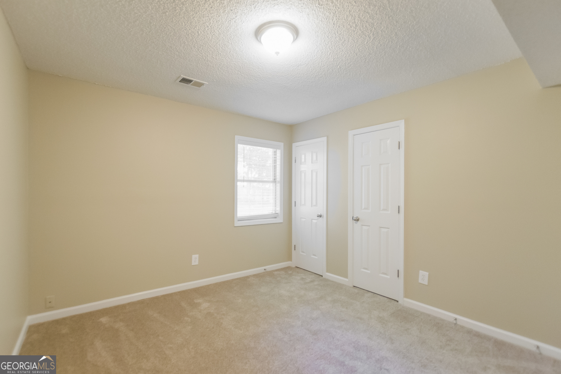 2353 Loren Falls Lane Southwest Marietta, GA 30008 - Photo 5 of 17 an empty room with windows