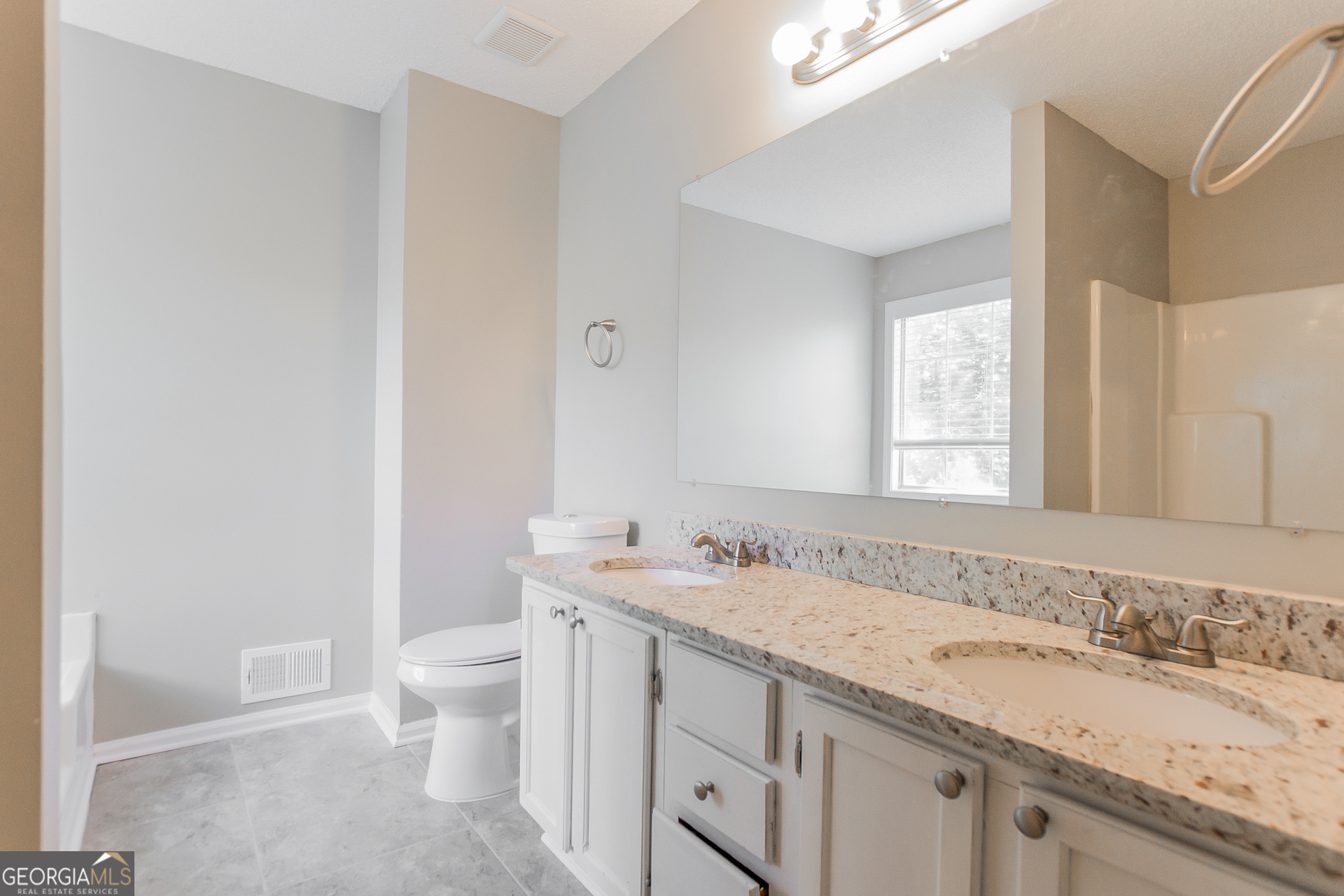 2353 Loren Falls Lane Southwest Marietta, GA 30008 - Photo 10 of 17 a bathroom with a granite countertop sink a toilet and a mirror