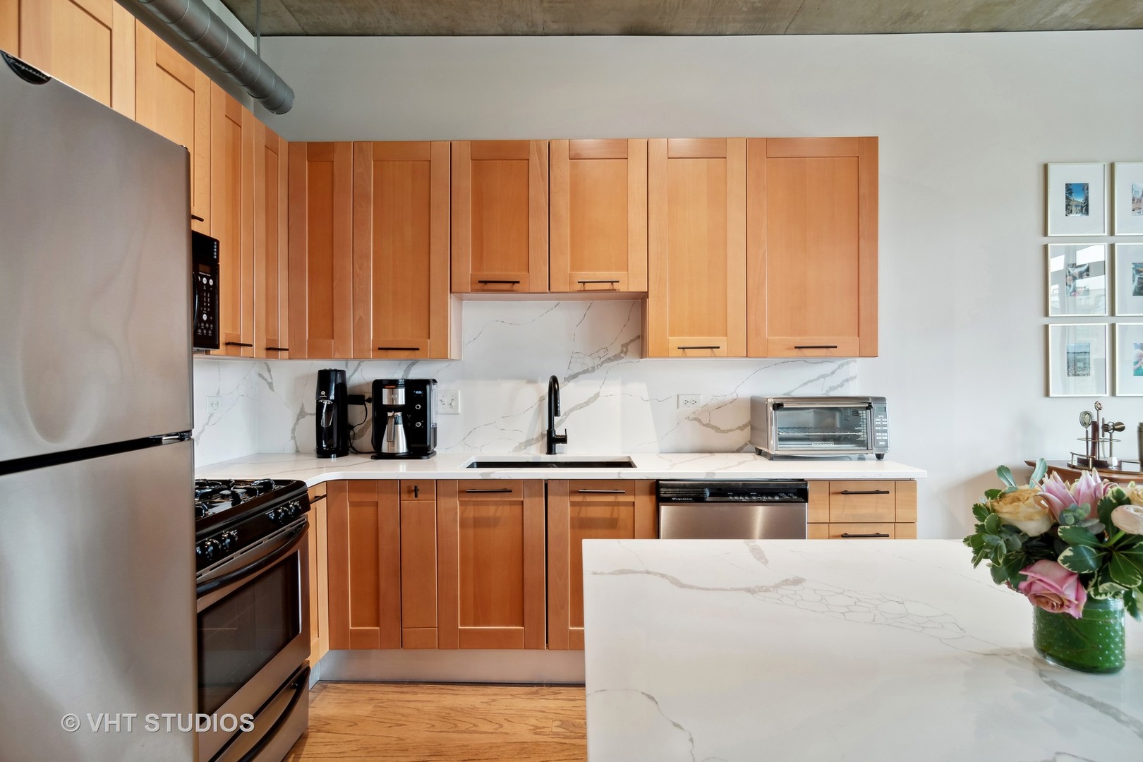 Undisclosed Address Chicago, IL 60607 - Photo 11 of 22 a kitchen with stainless steel appliances a stove a sink and white cabinets